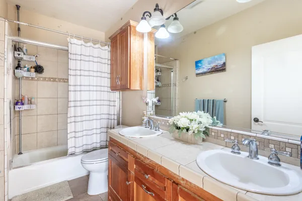 a bathroom with a sink a toilet and shower