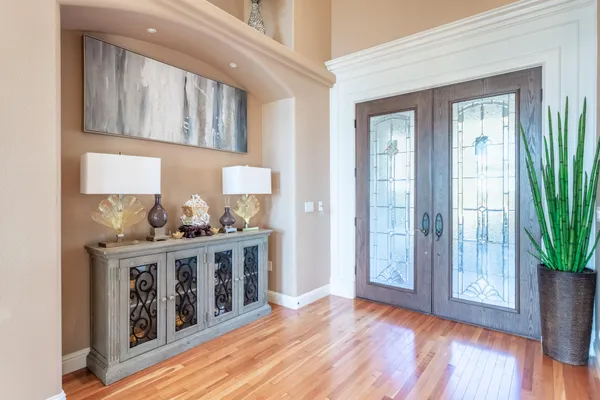 a kitchen with stainless steel appliances granite countertop a stove a refrigerator and a wooden floor