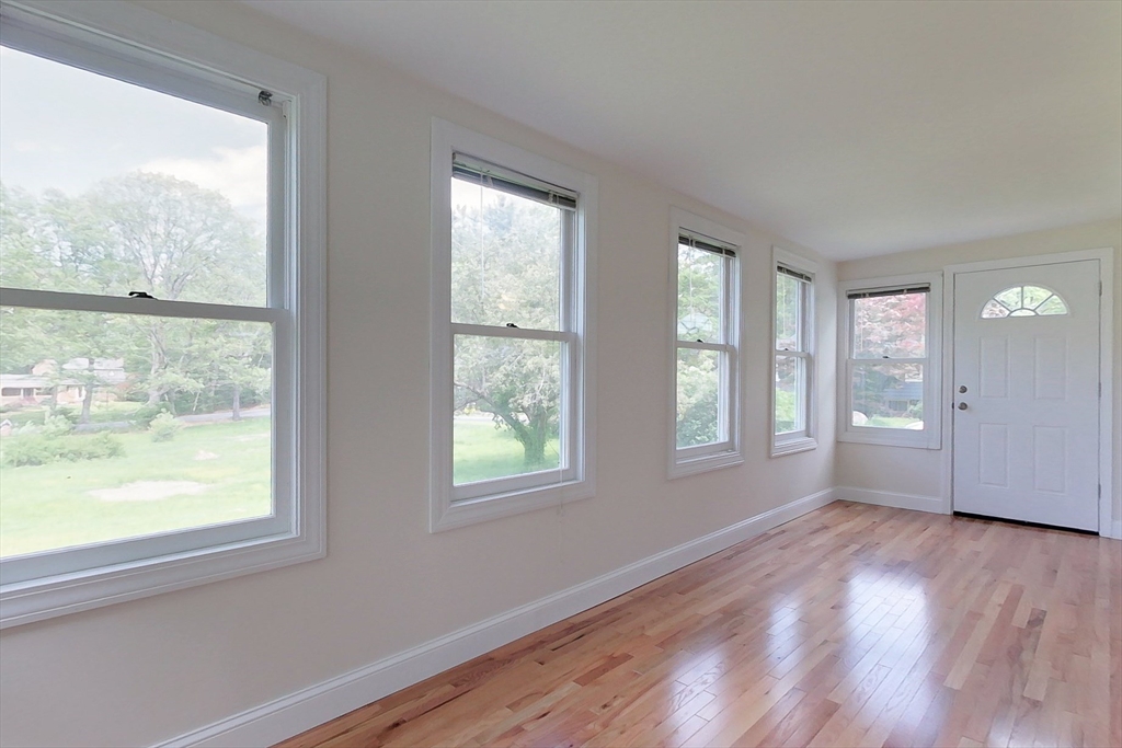 92 Squannacook Road Shirley, MA 01464 - Photo 7 of 38 a view of an empty room with wooden floor and a window
