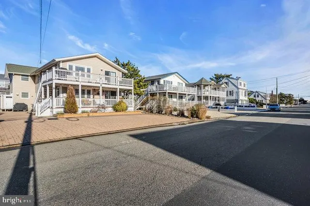 a bathroom with a sink a toilet a mirror a vanity and shower