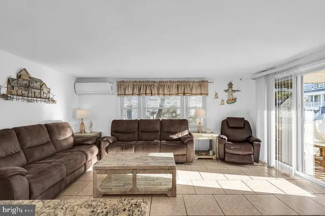 a view of a bedroom with wooden floor and window
