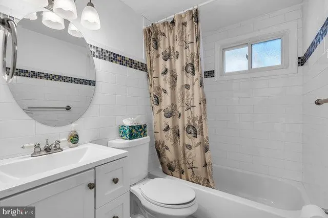 a bathroom with a bathtub a shower and a sink