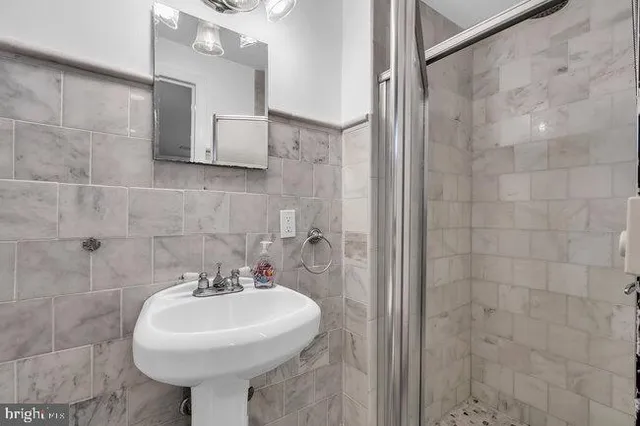 a living room with furniture a dining table and a chandelier