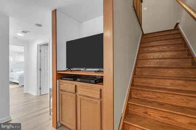 a bedroom with a bed and a television