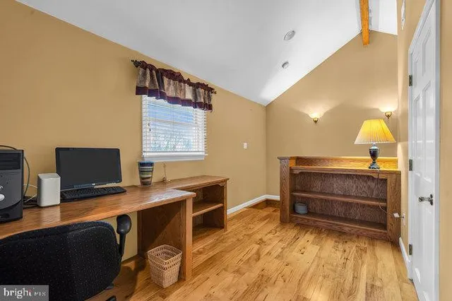 a bedroom with a bed a lamp and a window