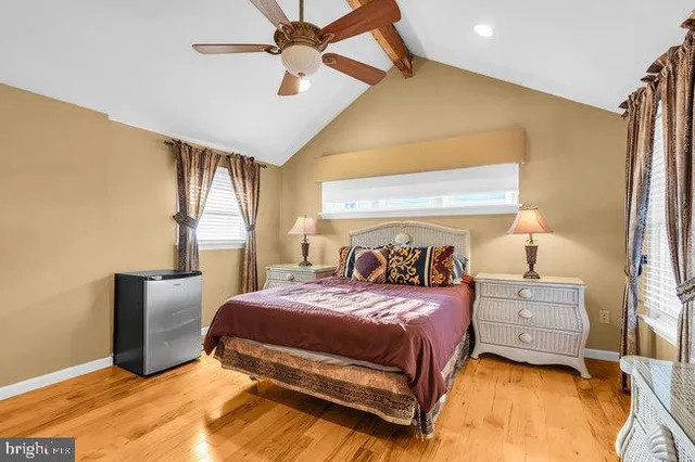 a kitchen with stainless steel appliances granite countertop a stove top oven a sink dishwasher a dining table and chairs with wooden floor