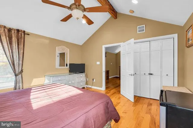 a living room with furniture a flat screen tv and a window