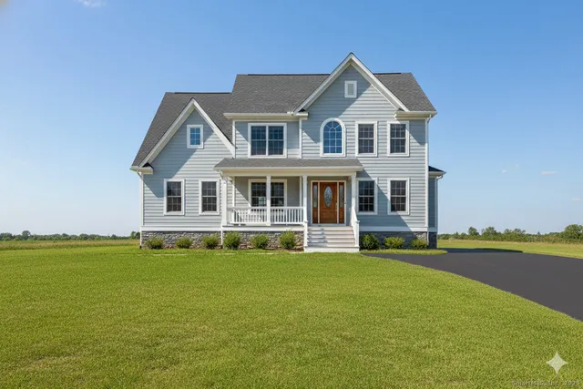 a front view of a house with a yard table and chairs