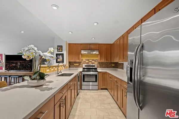 a kitchen with stainless steel appliances granite countertop a sink and stove
