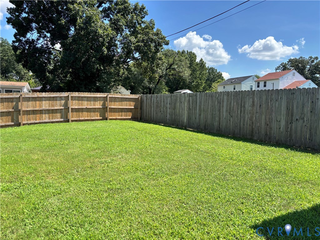 4513 Norborne Road Richmond, VA 23234 - Photo 8 of 10 Expansive grassy yard with a full perimeter wood p