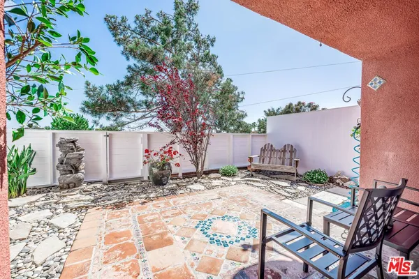 a backyard of a house with table and chairs