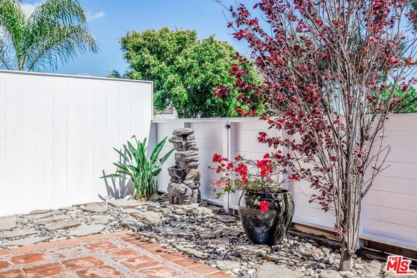 a view of a flower garden with a bench