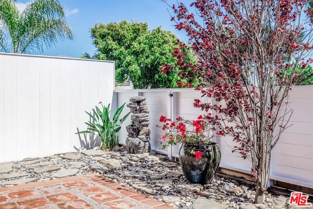 a view of a flower garden with a bench