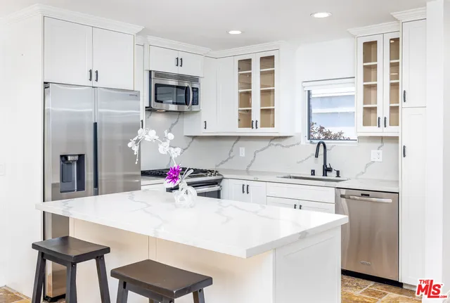 a kitchen with a stove a sink and a refrigerator