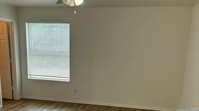 a view of a small space with wooden floor and a window