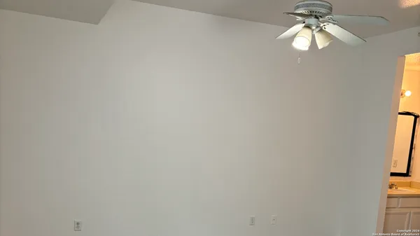 a fan in a room next to a window