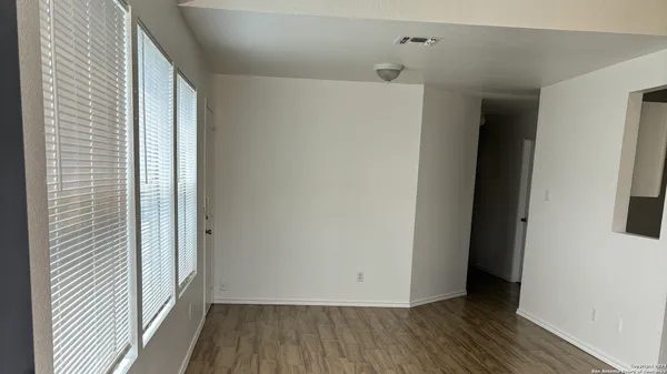a view of a room with wooden floor
