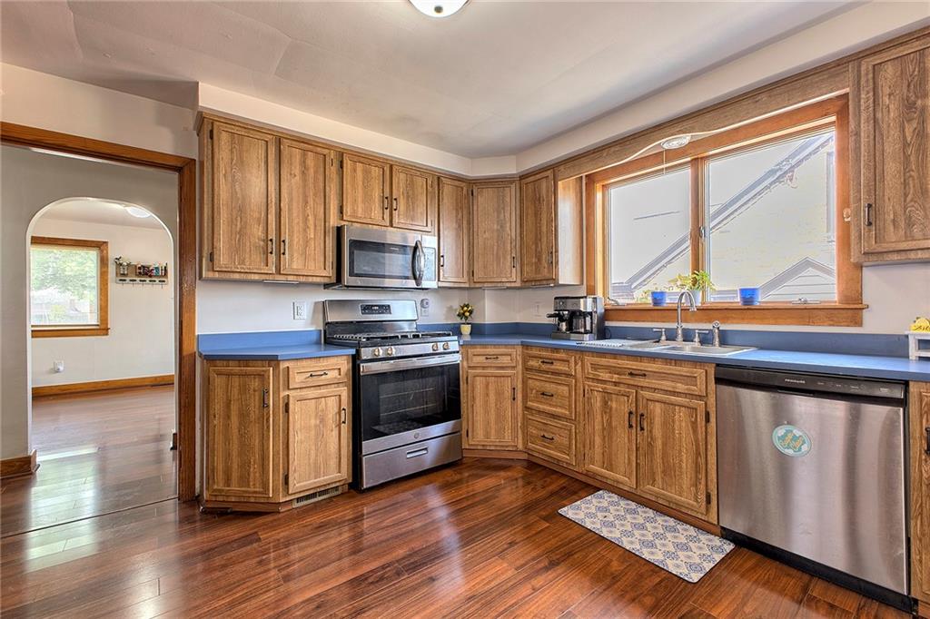 155 Lenox Street Uniontown, PA 15401 - Photo 14 of 32 a kitchen with stainless steel appliances granite countertop a stove a sink and a microwave