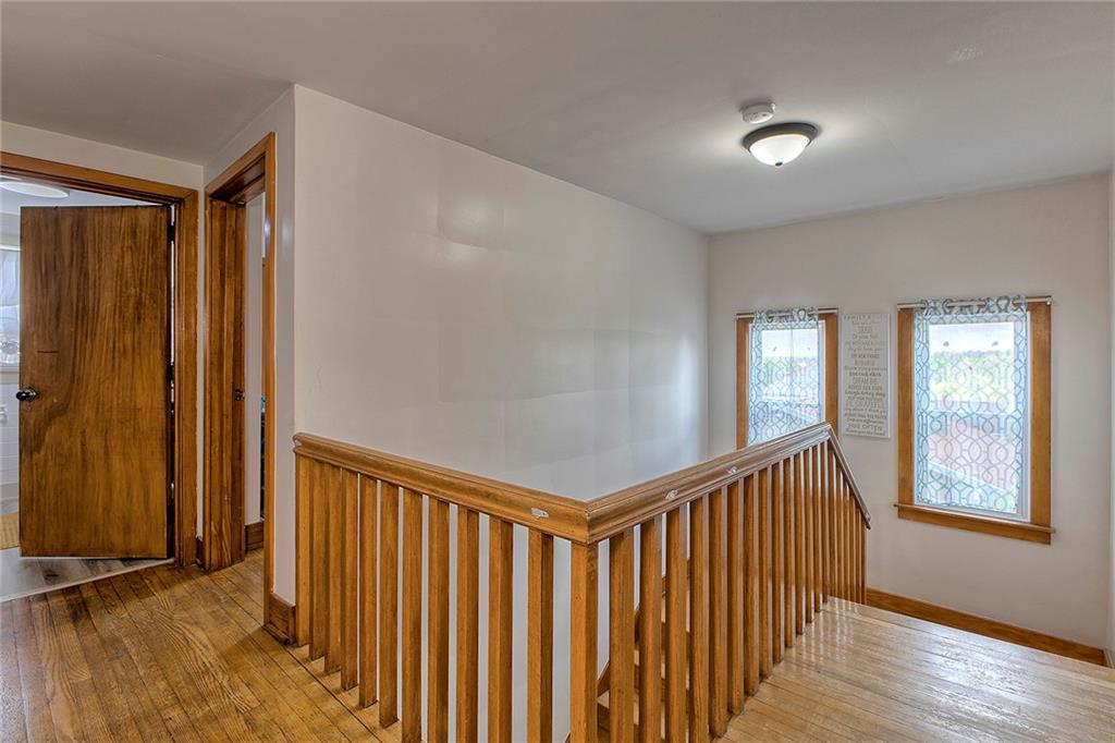 155 Lenox Street Uniontown, PA 15401 - Photo 18 of 32 a view of a hallway with wooden floor and windows