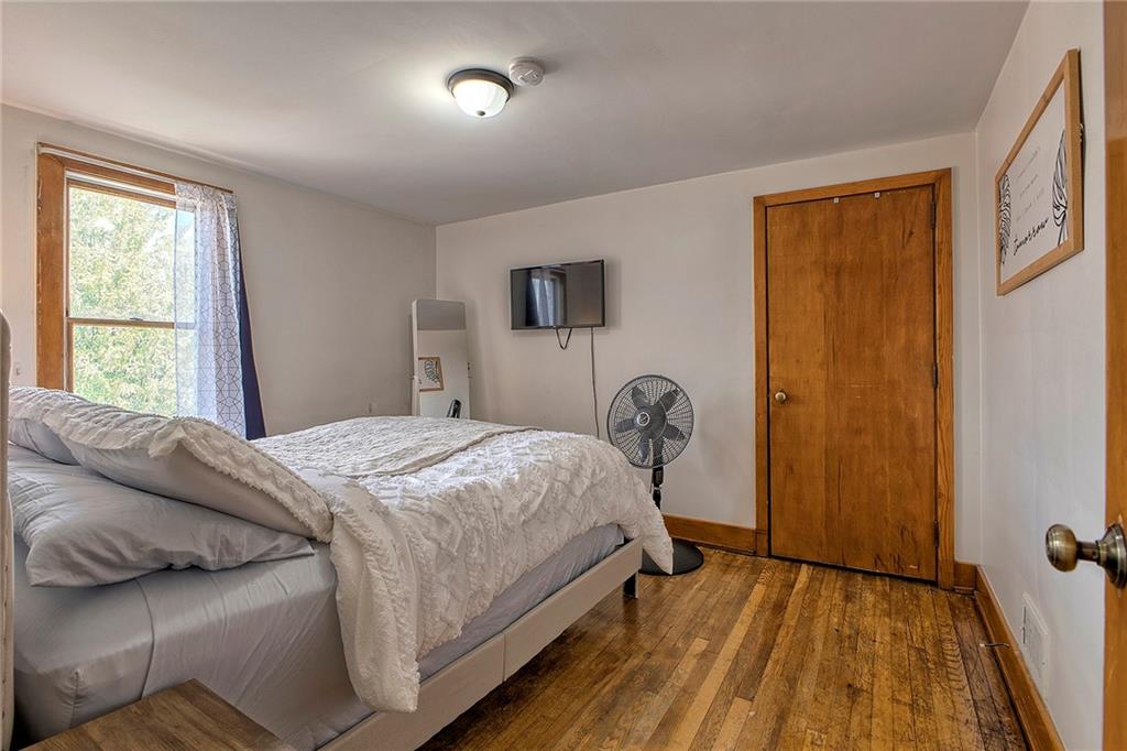 155 Lenox Street Uniontown, PA 15401 - Photo 19 of 32 a bedroom with a bed and wooden floor