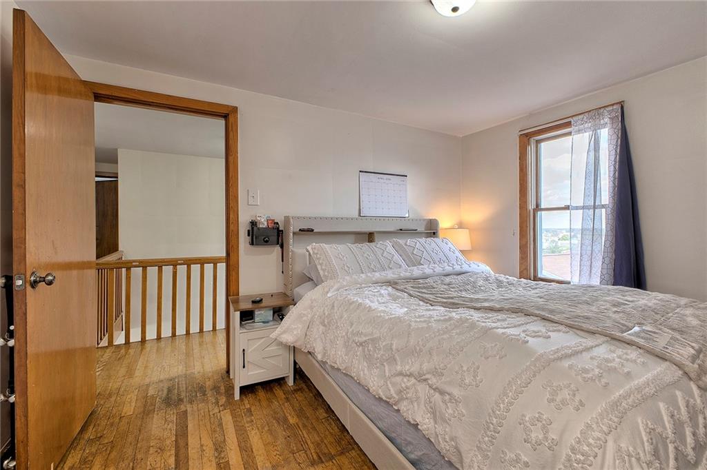 155 Lenox Street Uniontown, PA 15401 - Photo 20 of 32 a bedroom with a bed and wooden floor