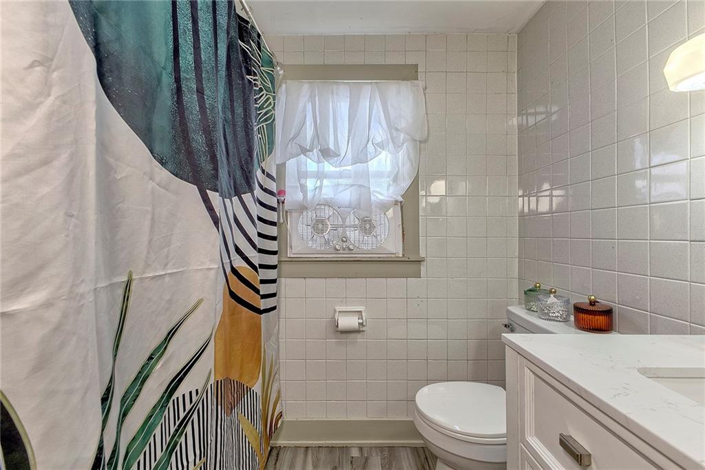 155 Lenox Street Uniontown, PA 15401 - Photo 26 of 32 a bathroom with a toilet and a shower curtain