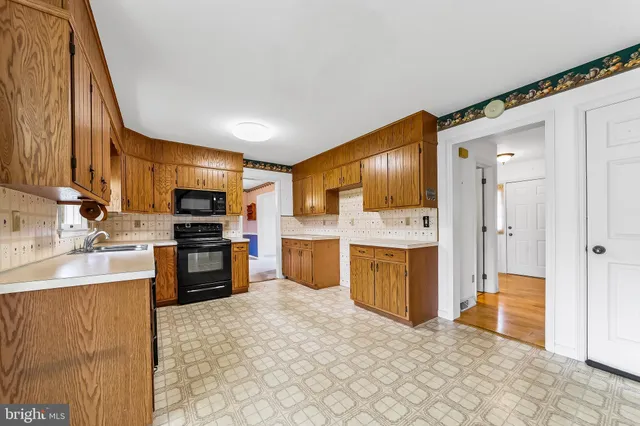 a kitchen with stainless steel appliances a refrigerator and a stove top oven