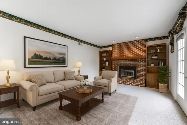 a living room with furniture a rug and a fireplace