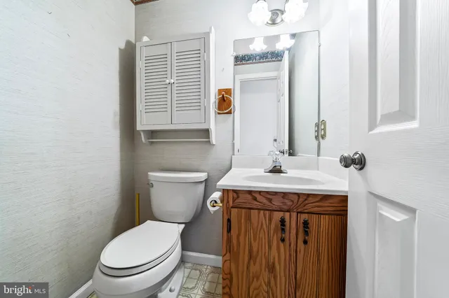 a bathroom with a sink a toilet and mirror
