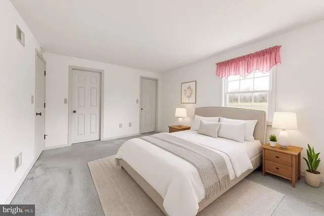 a bedroom with a bed and a large window