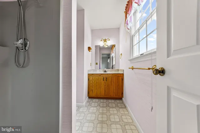 a bathroom with a sink vanity and mirror