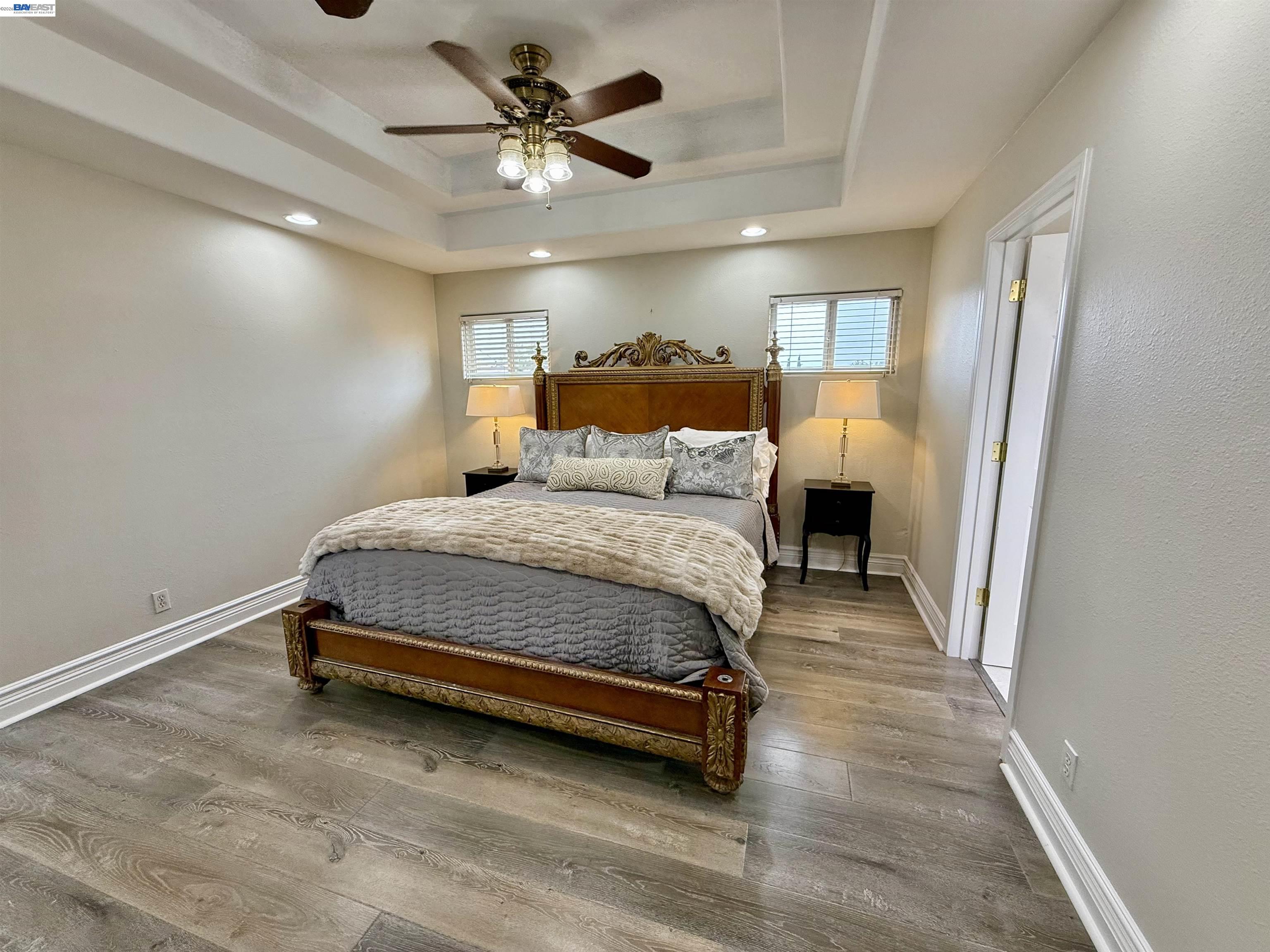 1284 Riesling Circle Livermore, CA 94550 - Photo 47 of 79 a bedroom with a bed and a chandelier