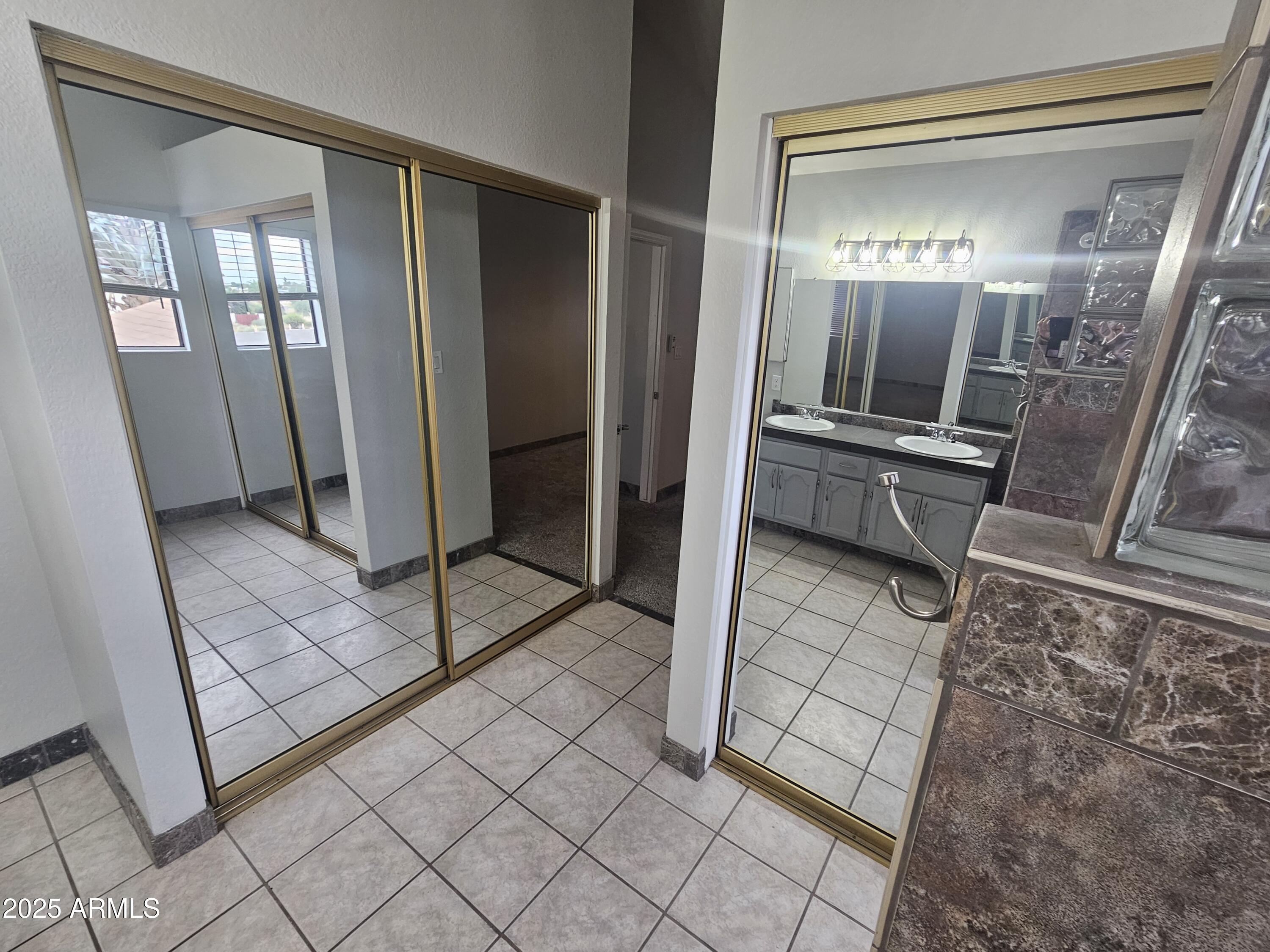 10032 West Sells Drive Phoenix, AZ 85037 - Photo 11 of 19 a bathroom with a mirror and a shower