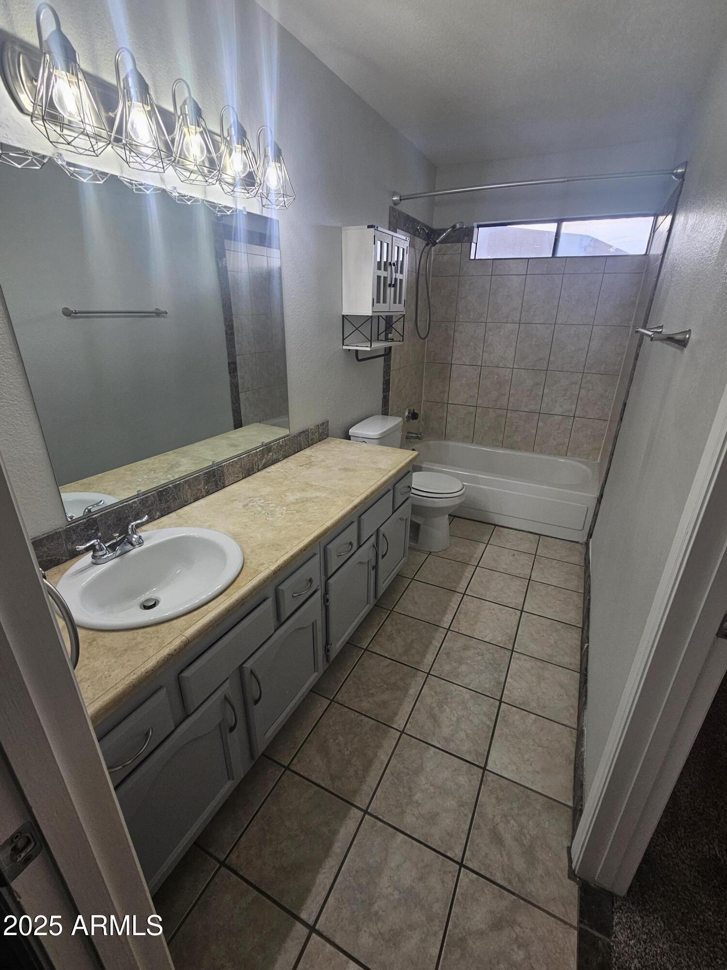 10032 West Sells Drive Phoenix, AZ 85037 - Photo 12 of 19 a bathroom with a sink a toilet and shower
