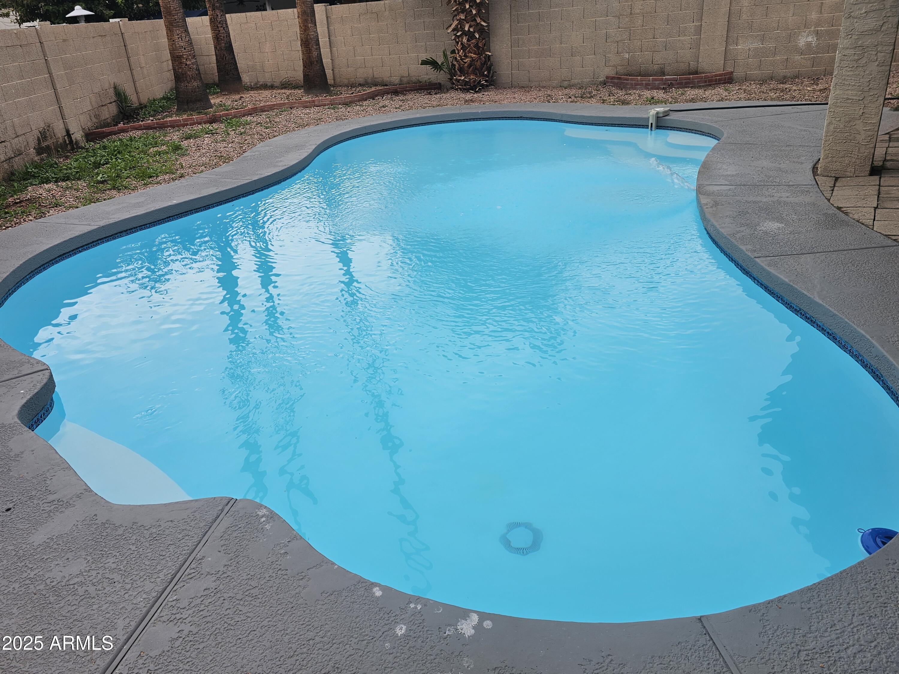 10032 West Sells Drive Phoenix, AZ 85037 - Photo 2 of 19 a view of a swimming pool with an outdoor space
