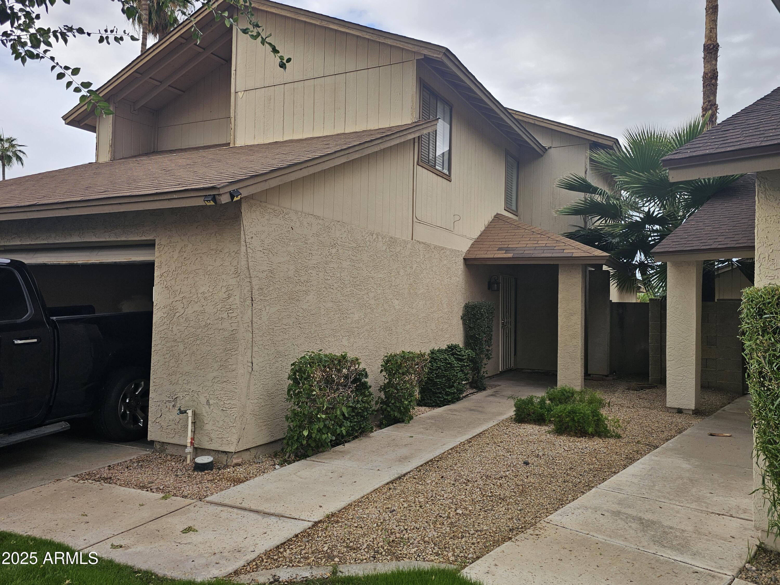 10032 West Sells Drive Phoenix, AZ 85037 - Photo 4 of 19 a front view of a house with garage