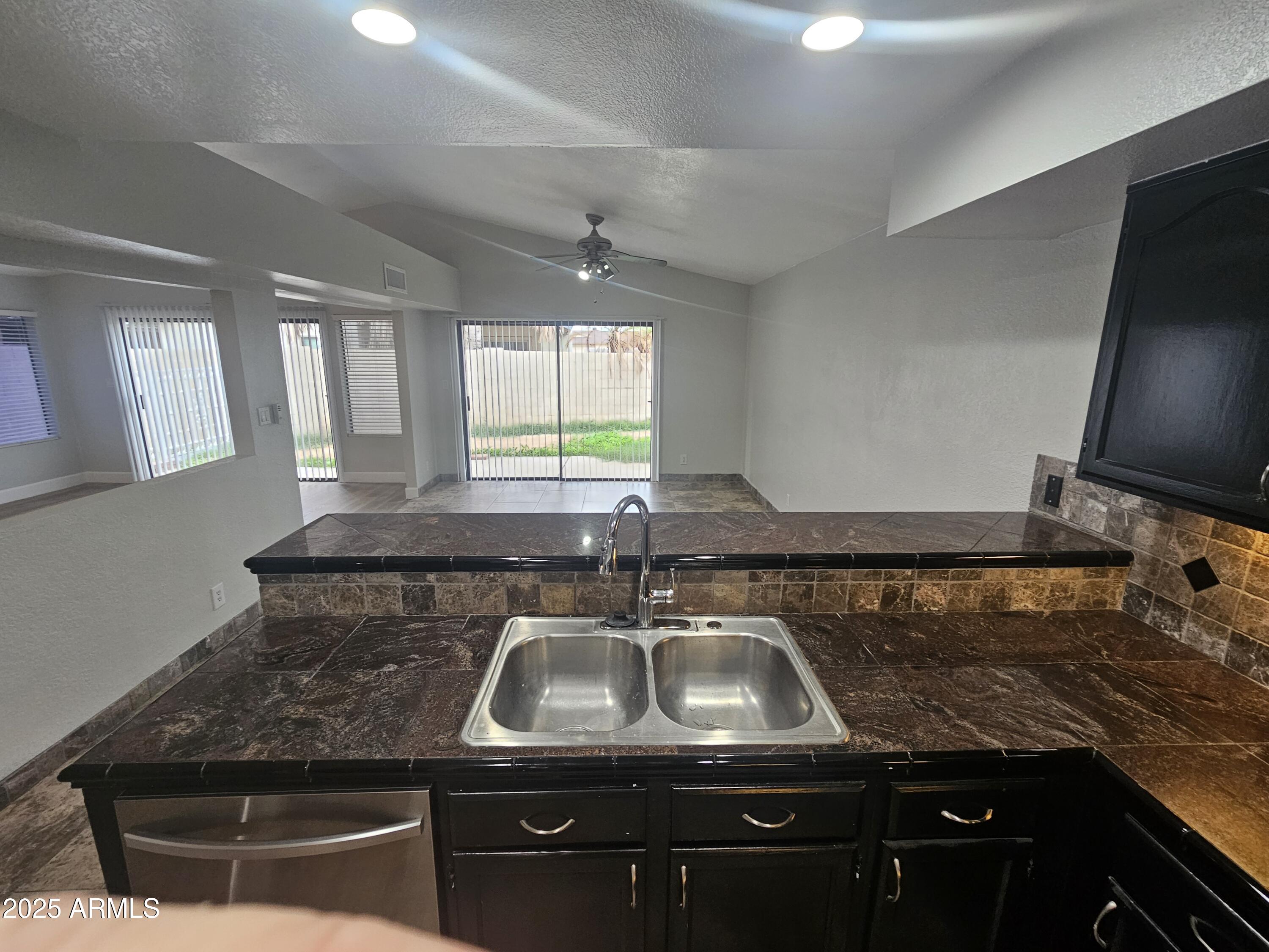 10032 West Sells Drive Phoenix, AZ 85037 - Photo 6 of 19 a kitchen with granite countertop a sink and a stove top oven