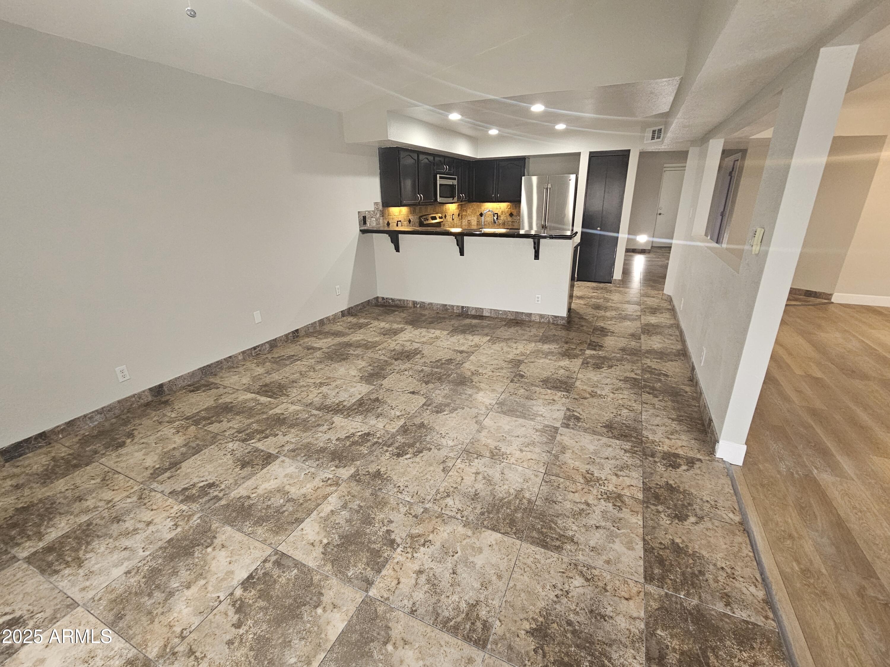 10032 West Sells Drive Phoenix, AZ 85037 - Photo 8 of 19 a view of empty room with wooden floor