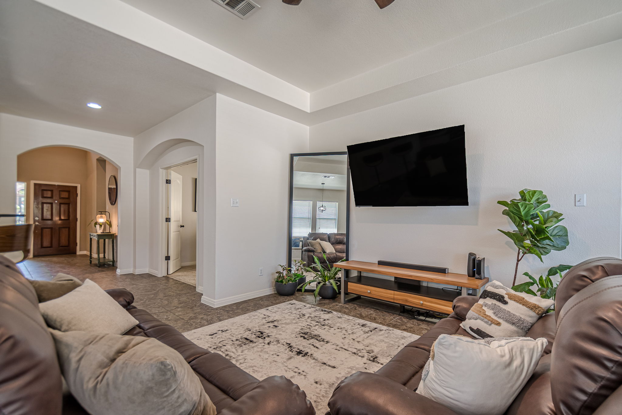 1031 Powell Kyle, TX 78640 - Photo 13 of 40 Tiled living area featuring arched walkways, a ceiling fan, and recessed lighting