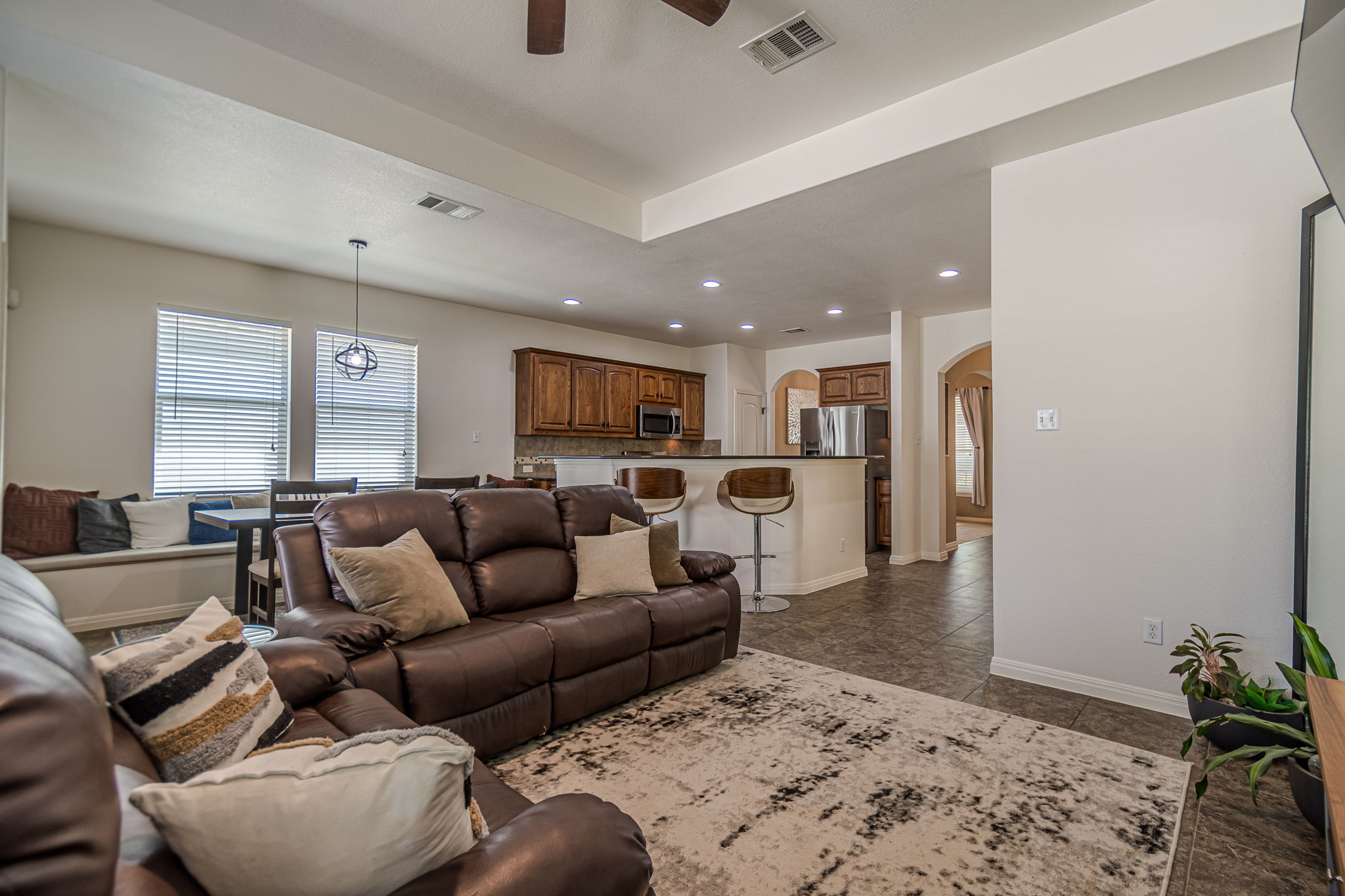 1031 Powell Kyle, TX 78640 - Photo 15 of 40 Living room with ceiling fan, recessed lighting, and arched walkways