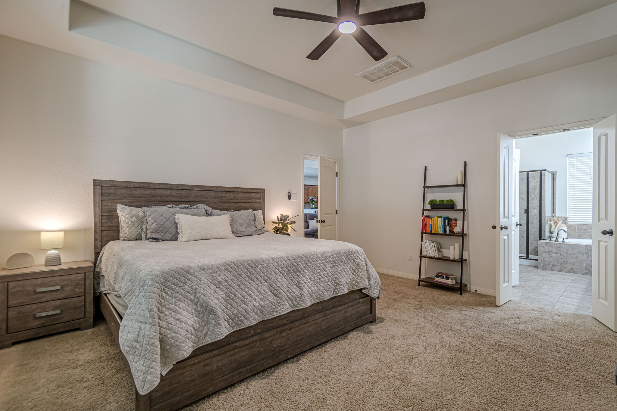 1031 Powell Kyle, TX 78640 - Photo 18 of 40 Carpeted bedroom featuring connected bathroom and ceiling fan