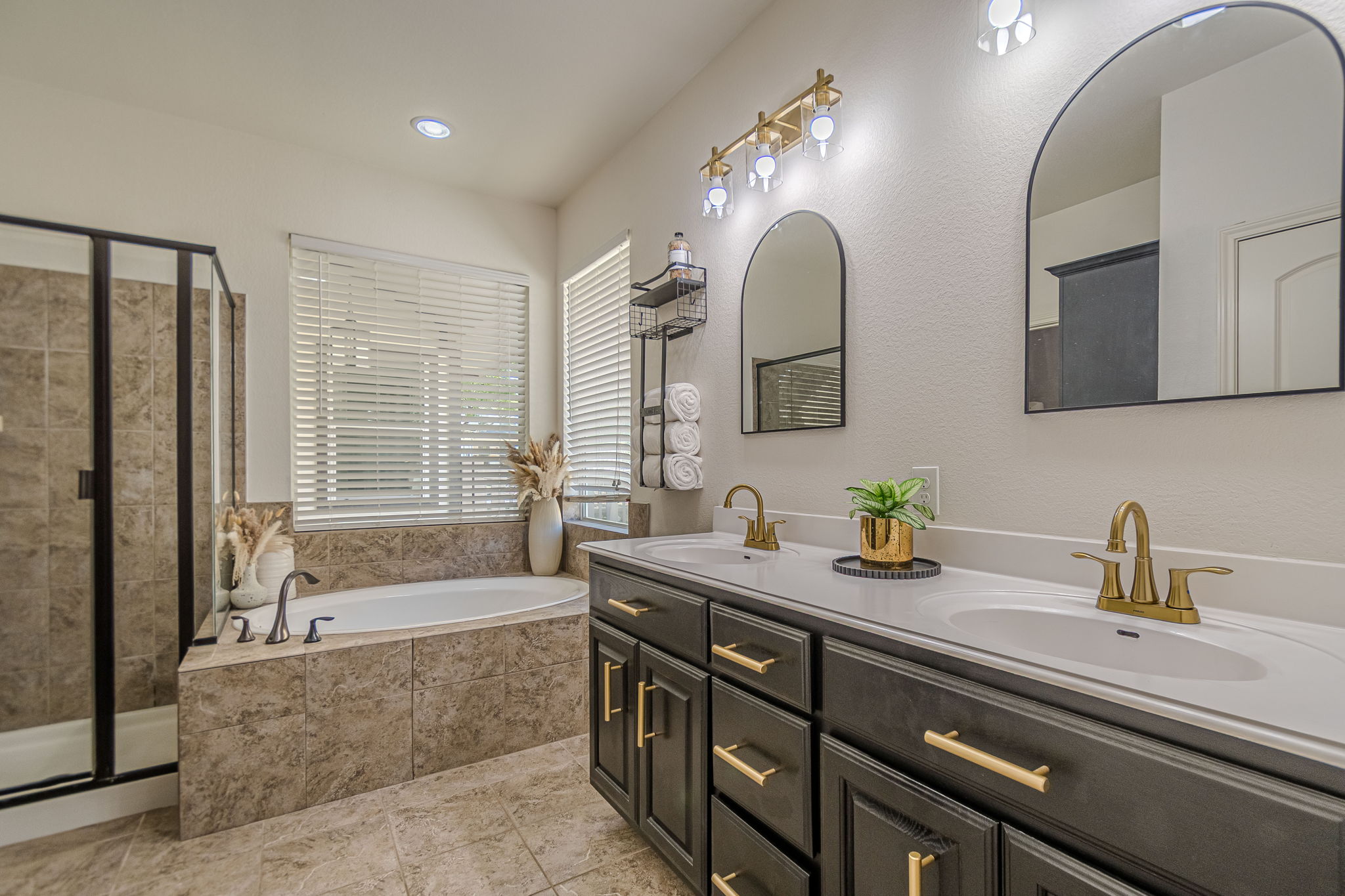 1031 Powell Kyle, TX 78640 - Photo 19 of 40 Bathroom featuring double vanity, a garden tub, a stall shower, recessed lighting, and light tile patterned floors