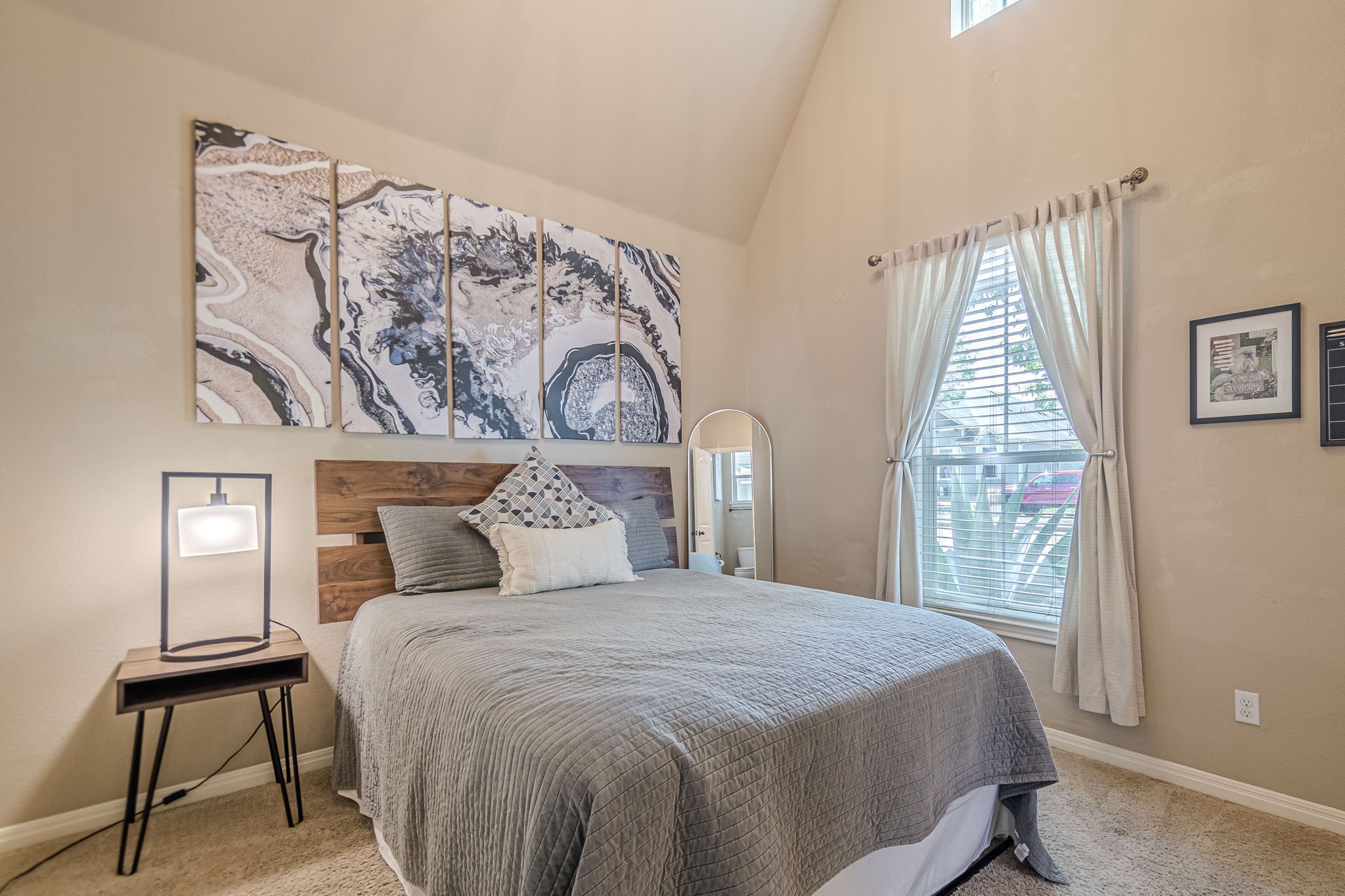 1031 Powell Kyle, TX 78640 - Photo 29 of 40 Bedroom 3 with light colored carpet and vaulted ceiling