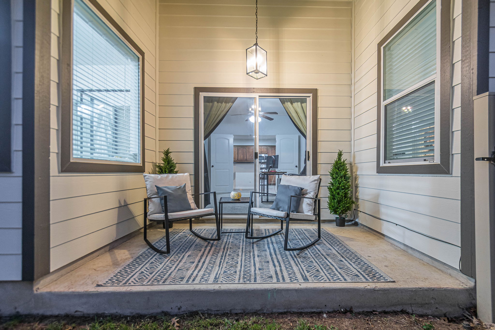 1031 Powell Kyle, TX 78640 - Photo 34 of 40 Twilight at covered porch off of the office/4th bedroom