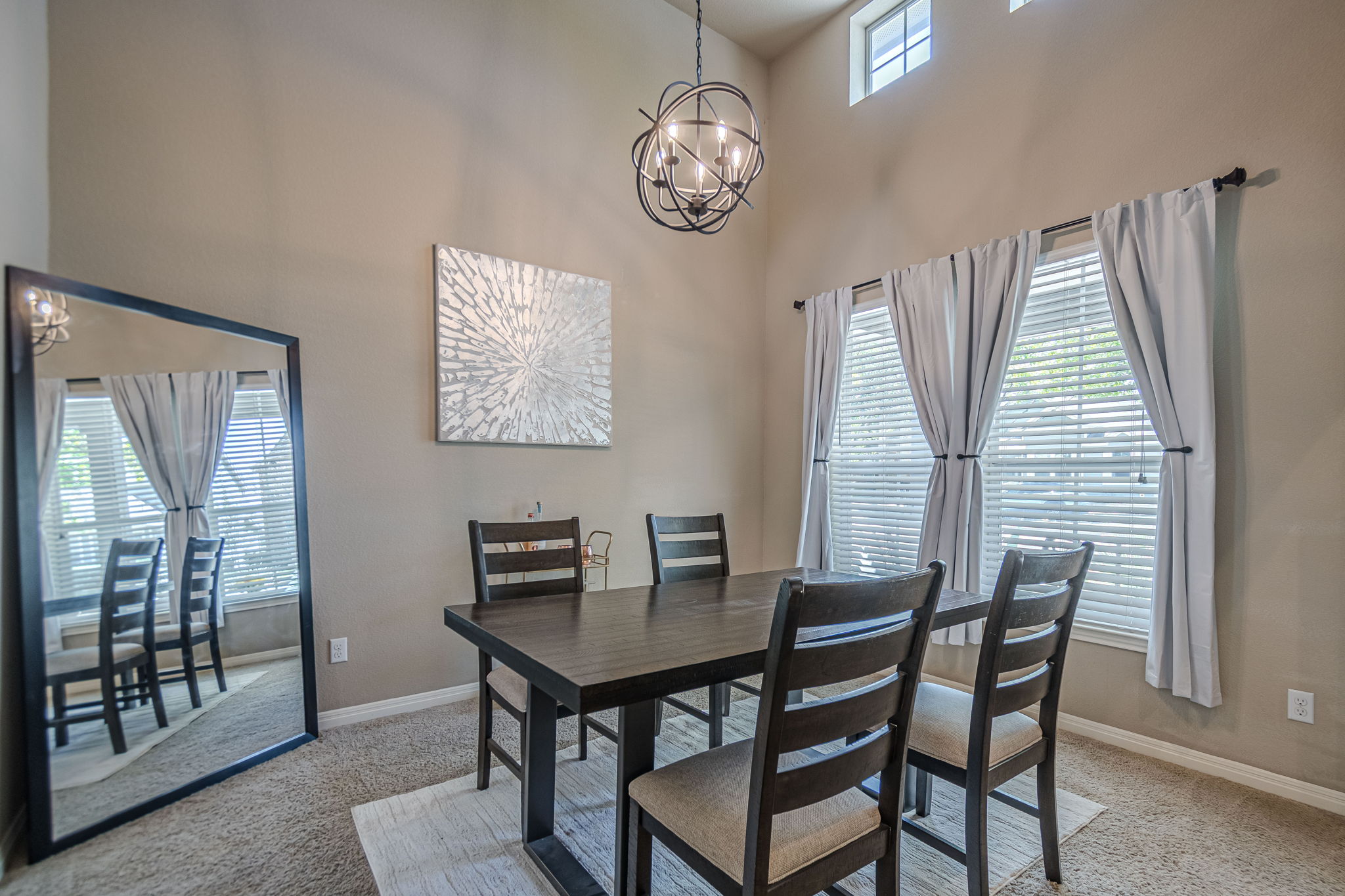 1031 Powell Kyle, TX 78640 - Photo 5 of 40 Dining room featuring a chandelier, light colored carpet, and a high ceiling
