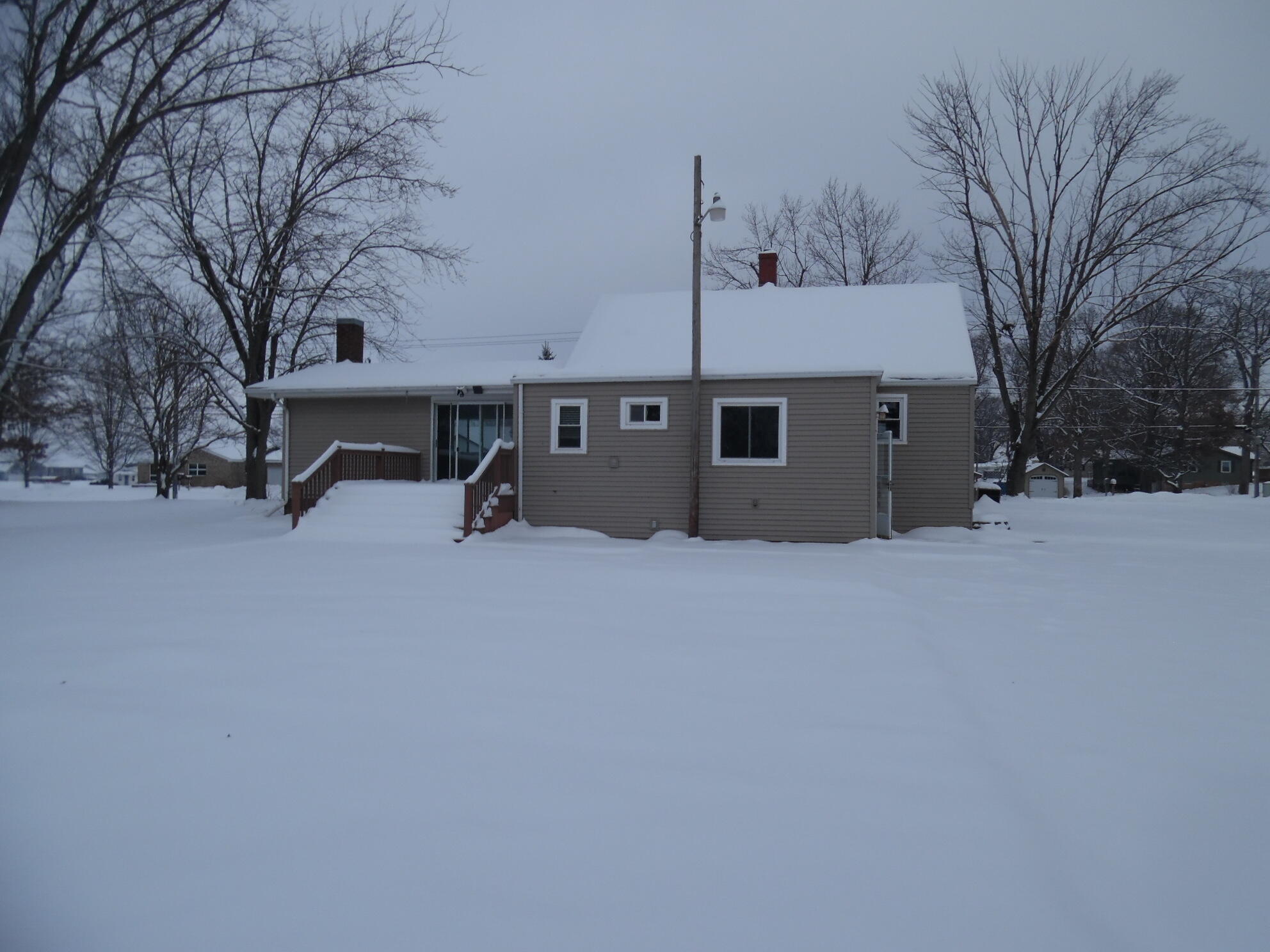 813 West Division Road De Motte, IN 46310 - Photo 3 of 20 a view of a house with a snow in the background