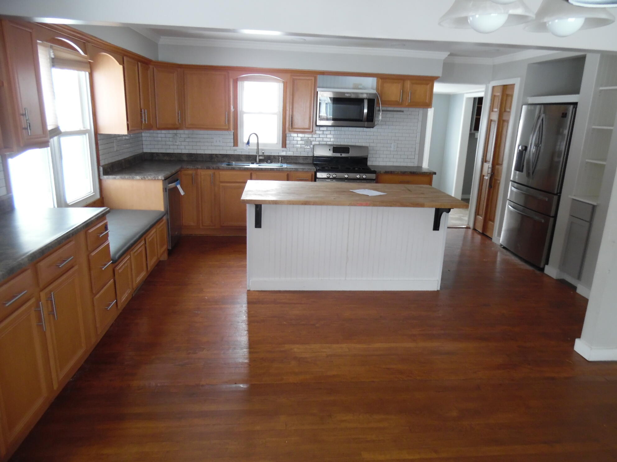 813 West Division Road De Motte, IN 46310 - Photo 6 of 20 a kitchen with stainless steel appliances granite countertop a refrigerator a stove top oven a sink and dishwasher