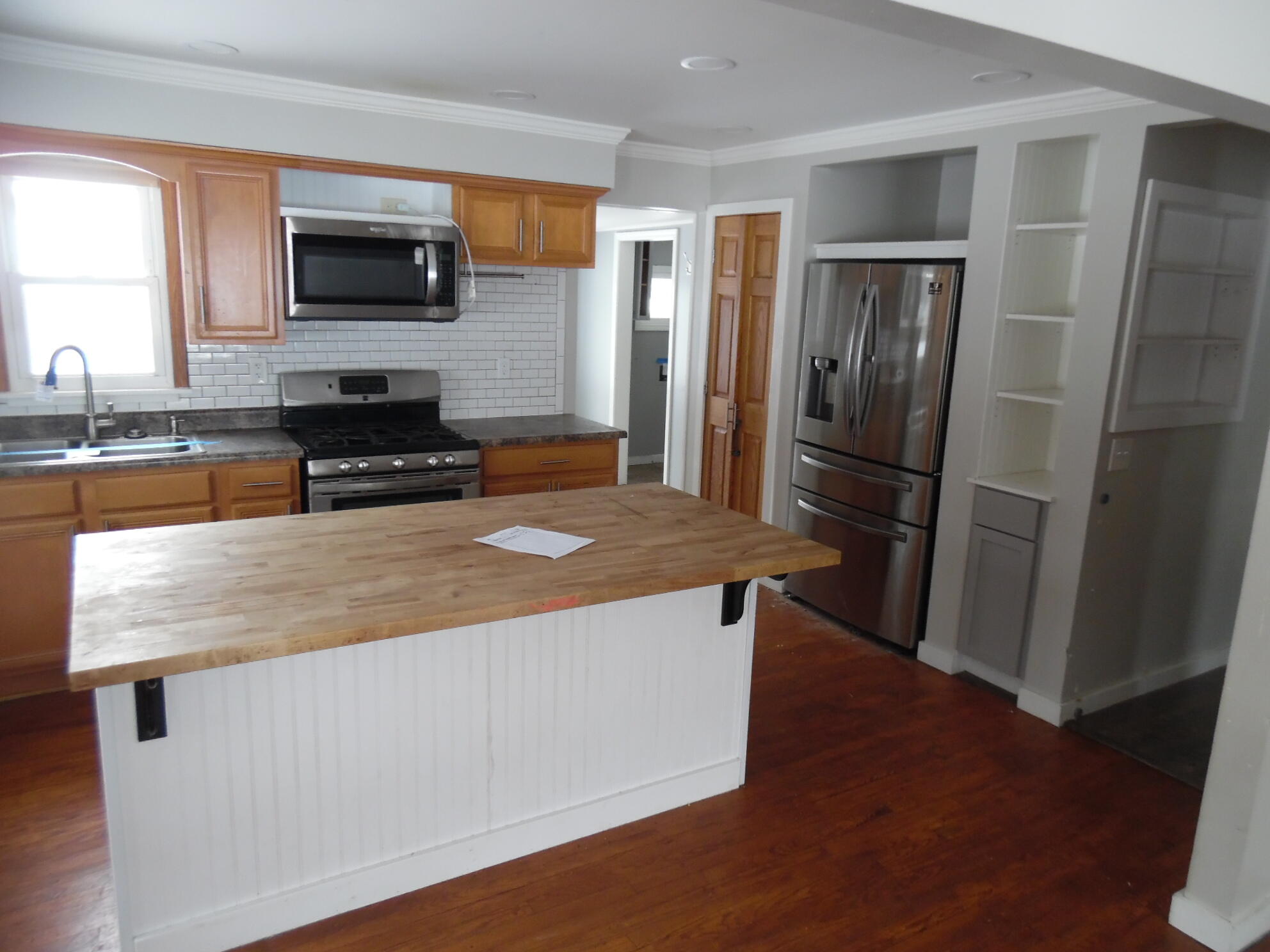 813 West Division Road De Motte, IN 46310 - Photo 8 of 20 a kitchen with stainless steel appliances wooden floor and a refrigerator