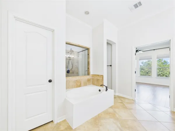 a bathroom with a tub shower and sink