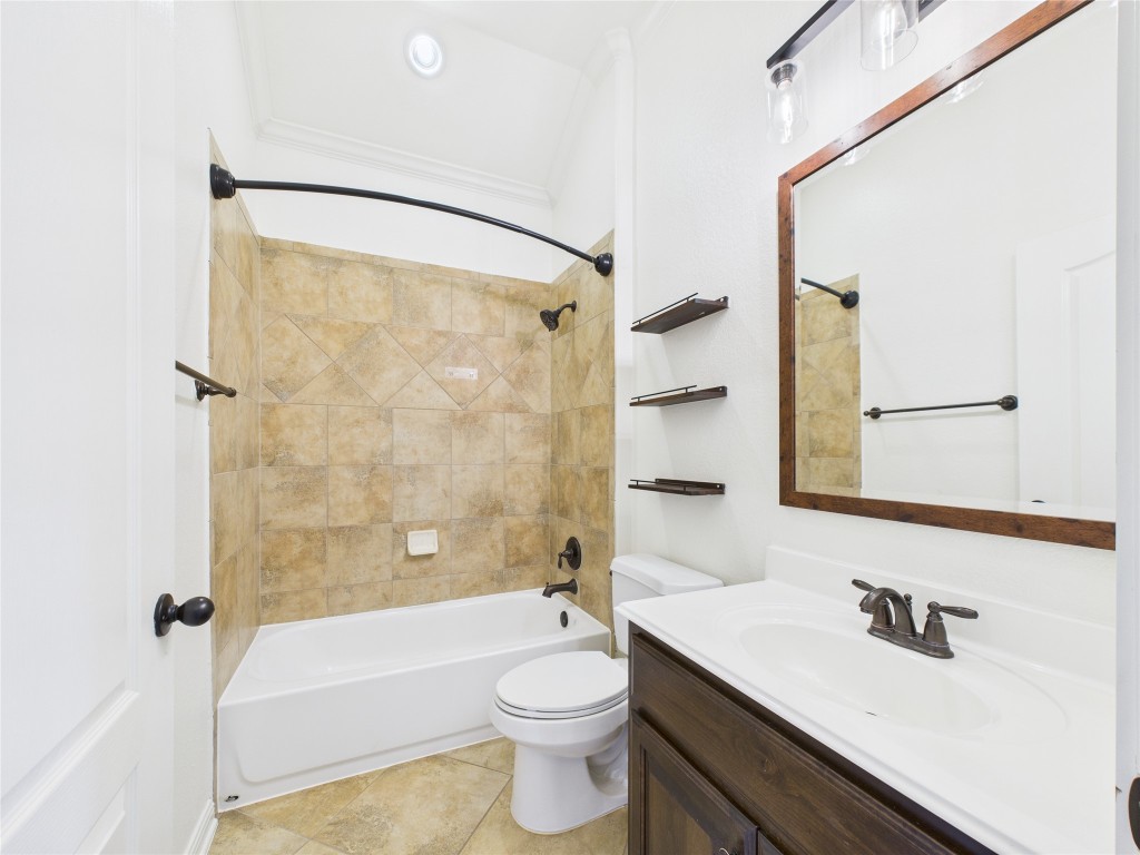 2624 Outlook Ridge Loop Leander, TX 78641 - Photo 25 of 39 a bathroom with a sink a toilet a mirror a bathtub and shower